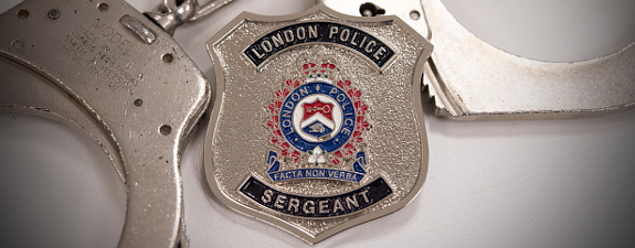 Police handcuffs and London Police Sergeant badge