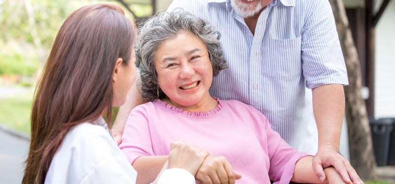 Elderly female receiving emotional support from family