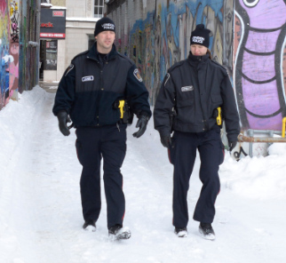 Two officers walking through an alley