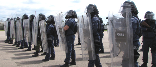 officer line up with riot gear on