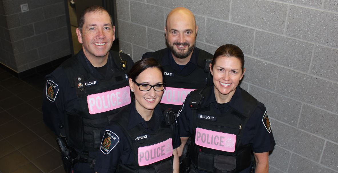 officers wearing pink police vest cover