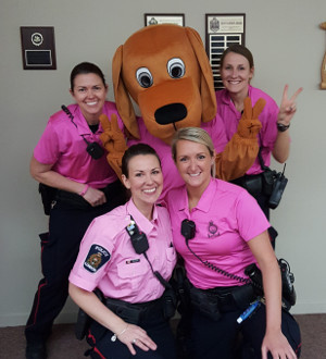 four officers in pink uniforms