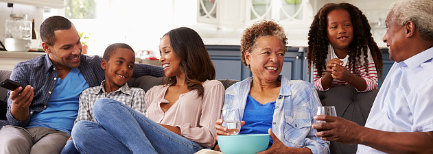 family sitting on couch, kids, parents, grandparents