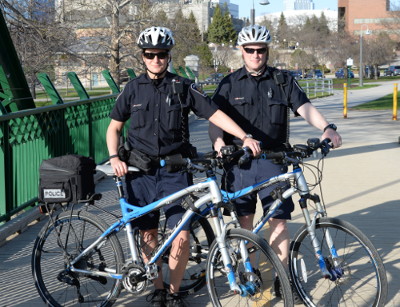 two bike patrol officers with their bikes